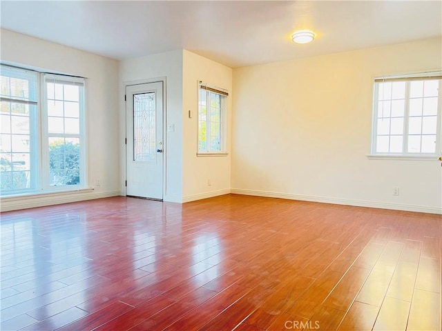 unfurnished room with wood-type flooring