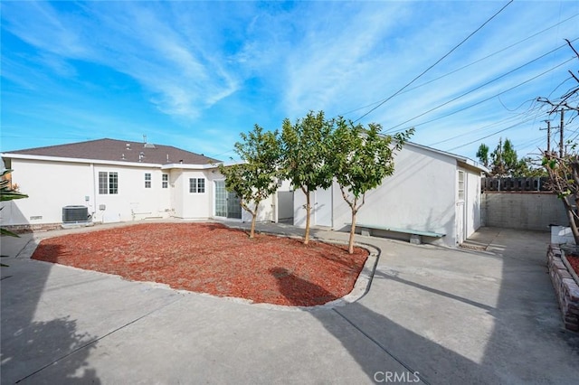 back of property with central air condition unit and a patio area