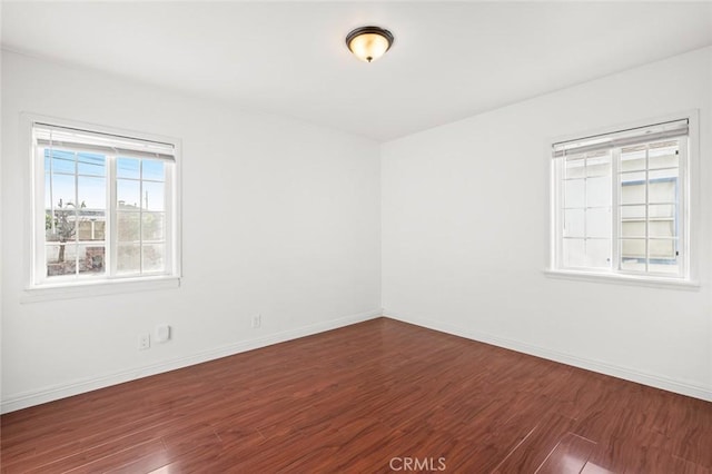 spare room with dark hardwood / wood-style flooring