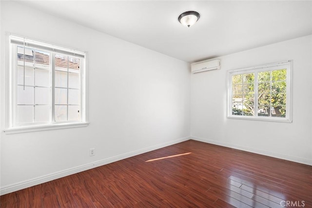 spare room featuring dark hardwood / wood-style flooring and a wall mounted AC