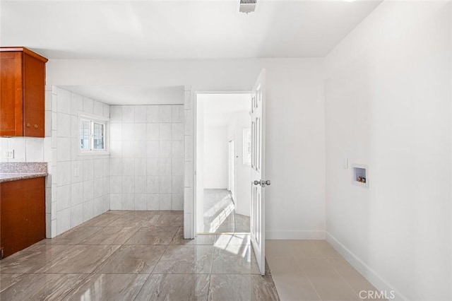 bathroom featuring tile walls and vanity