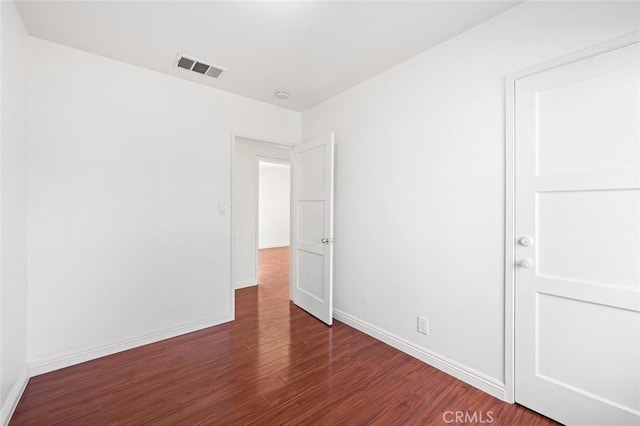 unfurnished room featuring dark hardwood / wood-style flooring