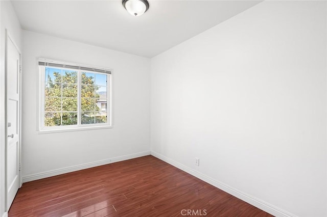 empty room featuring dark wood-type flooring