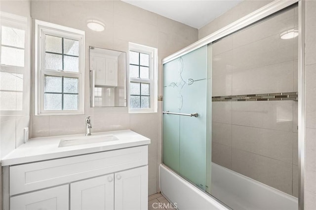 bathroom with vanity and combined bath / shower with glass door