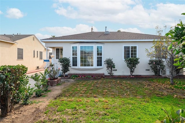 rear view of house with a yard