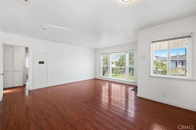 unfurnished room featuring dark hardwood / wood-style floors