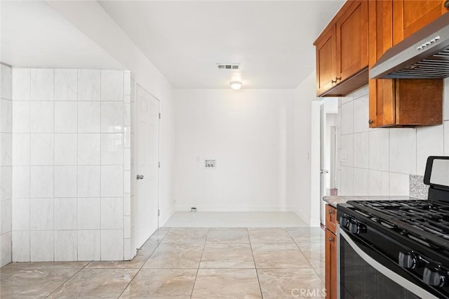 kitchen with tasteful backsplash, tile walls, range with gas stovetop, and wall chimney exhaust hood