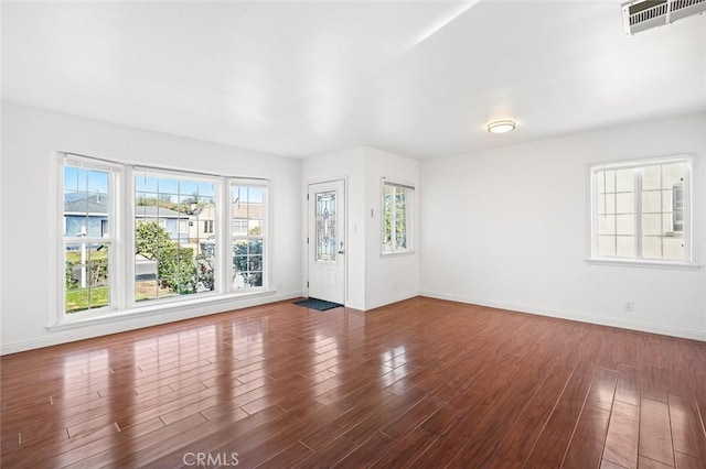 unfurnished living room featuring dark hardwood / wood-style floors