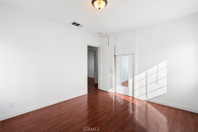 unfurnished room featuring dark hardwood / wood-style floors