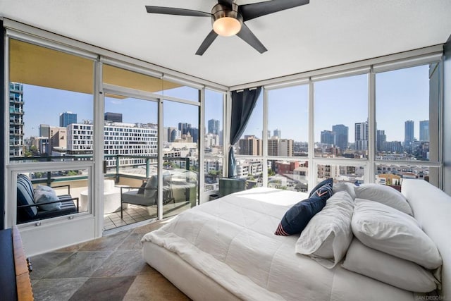 bedroom with ceiling fan and expansive windows