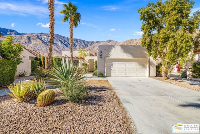 view of front of home featuring a garage and a mountain view