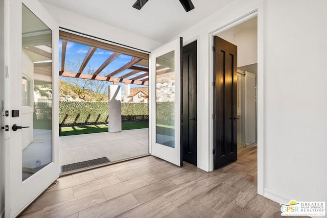 doorway featuring ceiling fan and french doors