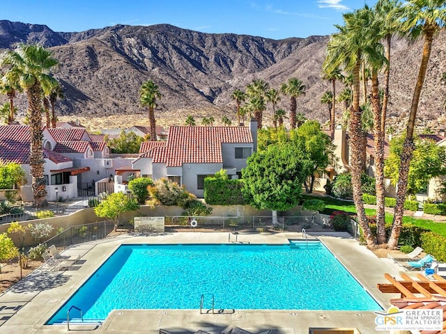 view of pool with a patio and a mountain view