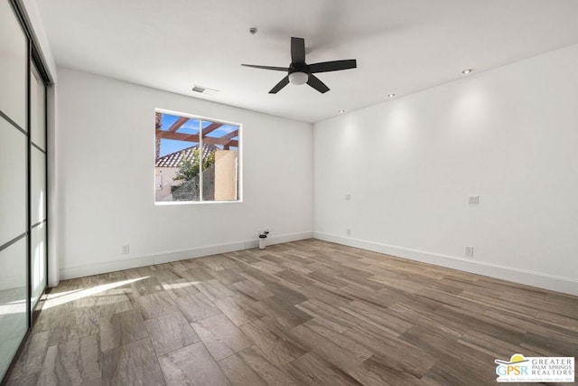 unfurnished room with hardwood / wood-style floors and ceiling fan