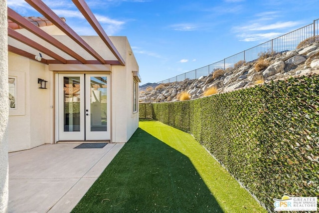 view of yard featuring a patio area and french doors