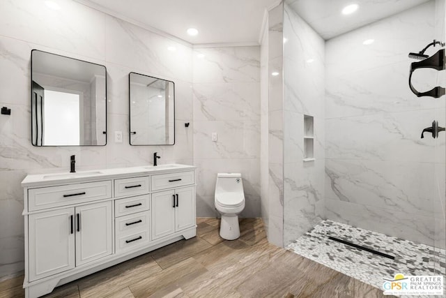 bathroom with ornamental molding, vanity, toilet, and tile walls