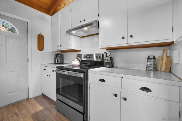 kitchen with stainless steel electric range, lofted ceiling, white cabinets, wooden ceiling, and light hardwood / wood-style flooring