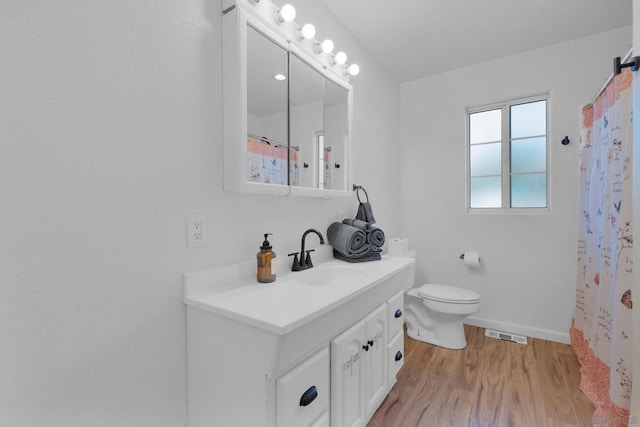 bathroom with hardwood / wood-style flooring, vanity, toilet, and a shower with curtain