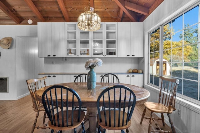 dining room with heating unit, an inviting chandelier, wooden ceiling, and light wood-type flooring