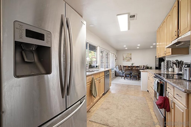 kitchen featuring light tile patterned floors, appliances with stainless steel finishes, and light brown cabinetry