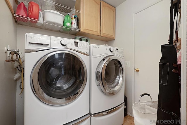 washroom featuring cabinets, light tile patterned floors, and separate washer and dryer