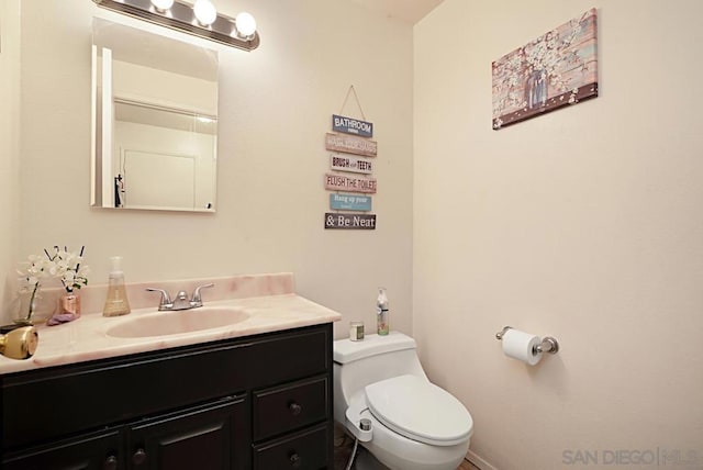 bathroom with toilet and vanity