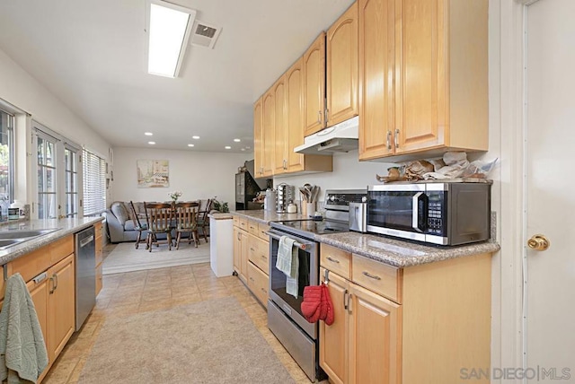 kitchen featuring light brown cabinets, stainless steel appliances, and light tile patterned flooring