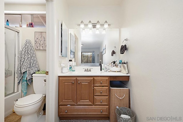 full bathroom featuring bath / shower combo with glass door, toilet, and vanity