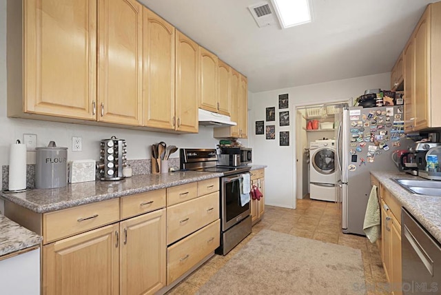 kitchen featuring washer / dryer, sink, stainless steel appliances, light tile patterned floors, and light brown cabinetry