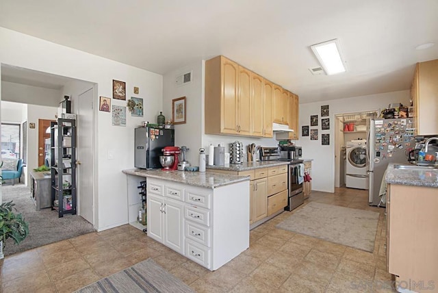 kitchen with light colored carpet, washer / clothes dryer, appliances with stainless steel finishes, light brown cabinetry, and light stone counters