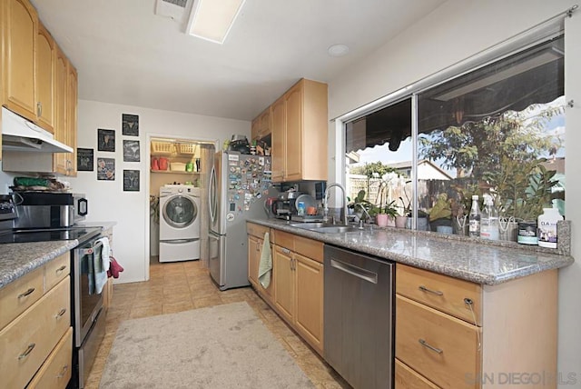 kitchen with appliances with stainless steel finishes, washer / clothes dryer, light brown cabinets, sink, and light stone counters