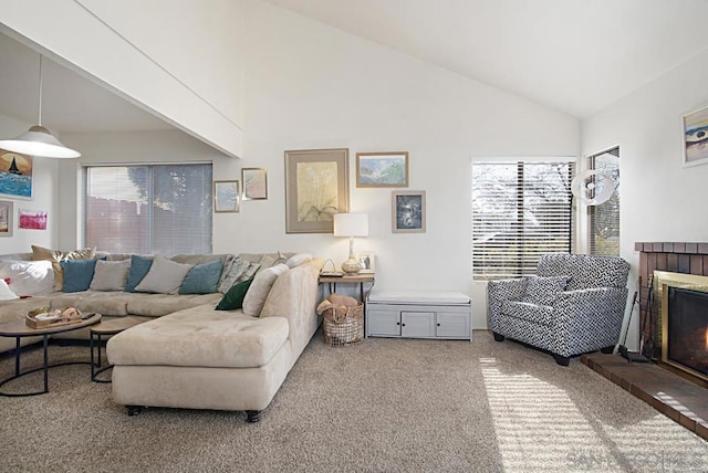 carpeted living room with high vaulted ceiling and a brick fireplace