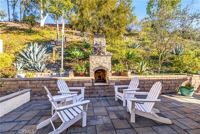 view of patio with an outdoor stone fireplace