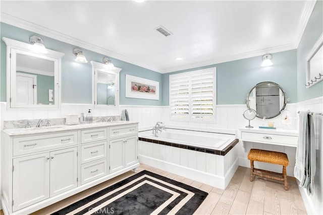 bathroom featuring vanity, a bathing tub, crown molding, and hardwood / wood-style floors