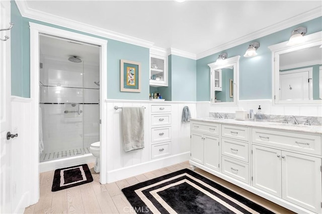 bathroom with toilet, hardwood / wood-style flooring, an enclosed shower, crown molding, and vanity