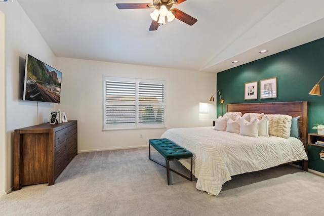 bedroom with light carpet, ceiling fan, and vaulted ceiling