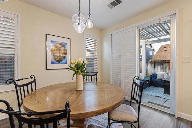 dining area with dark hardwood / wood-style flooring