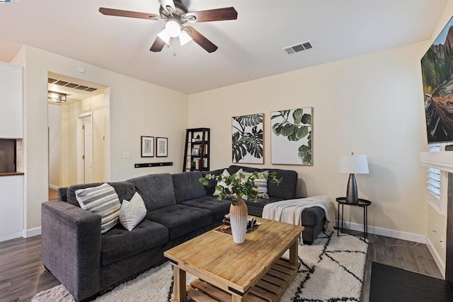 living room featuring hardwood / wood-style flooring and ceiling fan