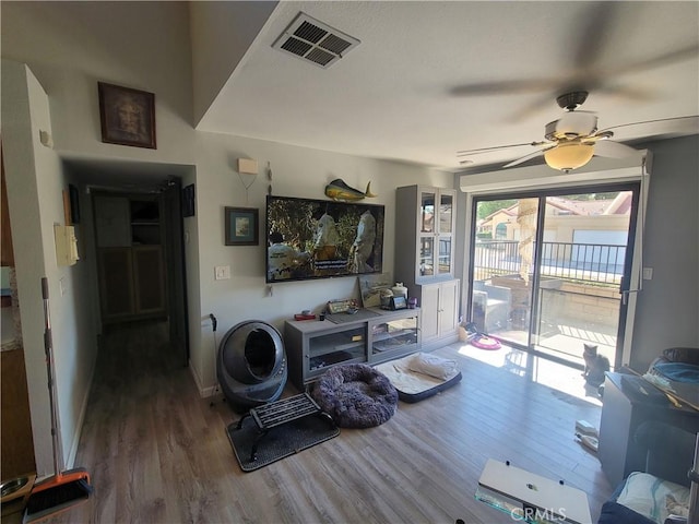 interior space with ceiling fan and wood-type flooring