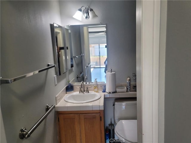 bathroom featuring toilet and vanity