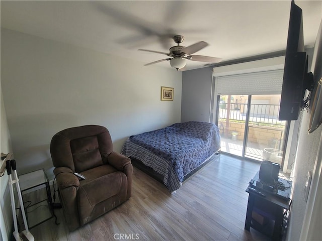 bedroom featuring ceiling fan, access to exterior, and hardwood / wood-style floors