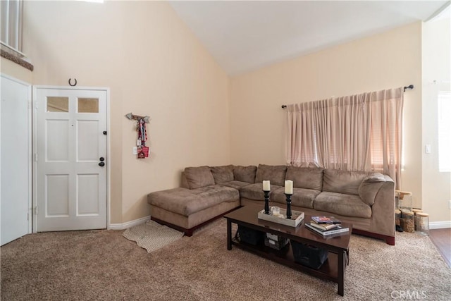 living room featuring carpet and high vaulted ceiling