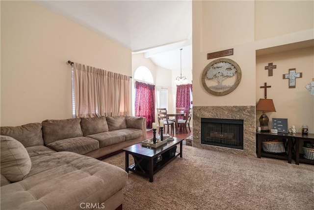 living room with a fireplace and high vaulted ceiling