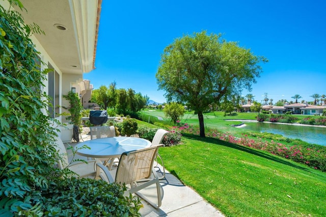 view of yard featuring a water view and a patio