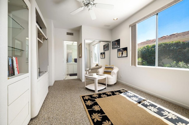 interior space with ceiling fan and carpet floors