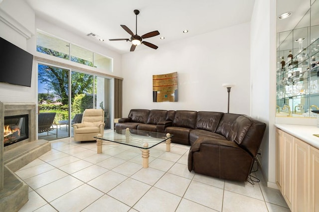 living room featuring ceiling fan and light tile patterned floors