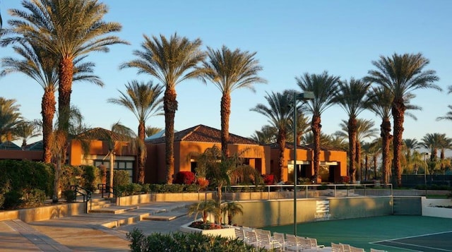 view of swimming pool with tennis court