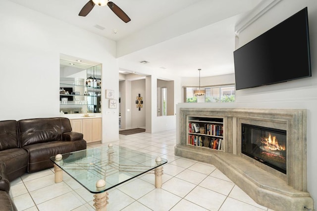 living room with ceiling fan, light tile patterned floors, and sink