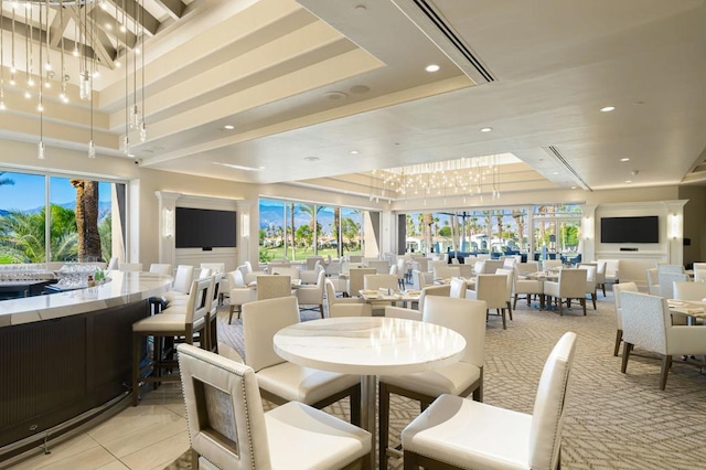 tiled dining space featuring a tray ceiling