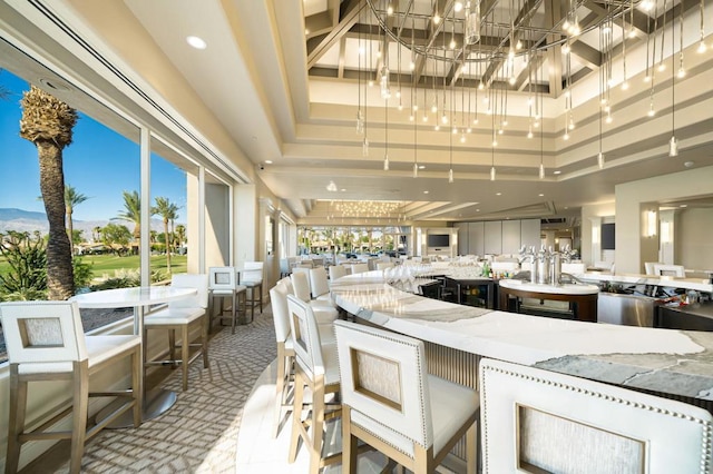 kitchen featuring a high ceiling, light stone countertops, and a tray ceiling